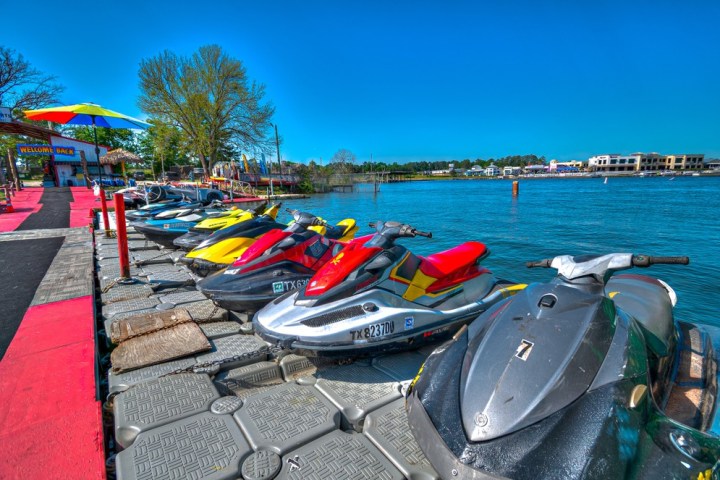 a row of parked motorcycles sitting on the beach