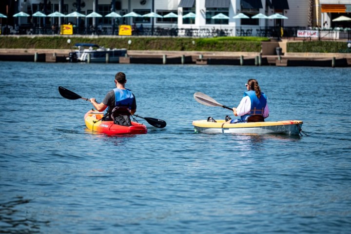 a group of people rowing a boat in the water