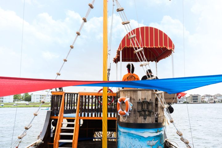 a person sitting in a boat on a body of water