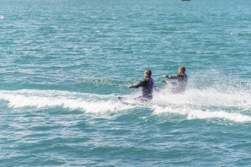 a man riding a wave on a surfboard in the water