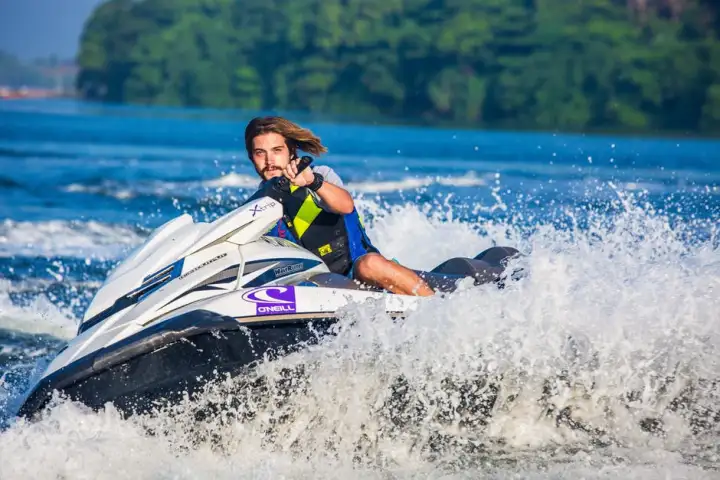 a man riding a wave on a surf board on a body of water