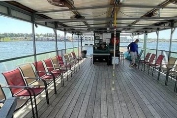 a group of people sitting at a dock